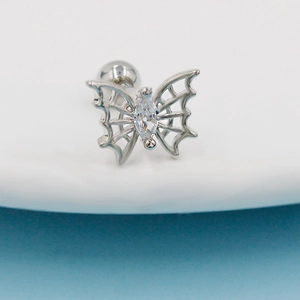Macro view of silver butterfly cartilage stud with marquise zircon and screw ball back