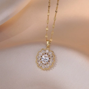 Elegant gold necklace featuring an oval white zircon and floral diamond pendant sparkle