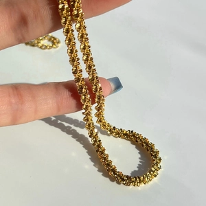 Sparkling 18k gold braided chain necklace with high-shine woven popcorn link design