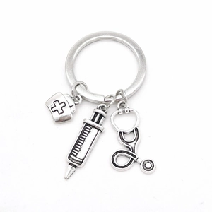 Nurse themed medical keychain with stethoscope, syringe and nurse hat charms in silver finish