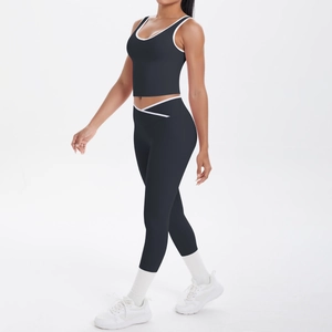 Detail of black yoga set with white contrast trim and high waist shaping leggings