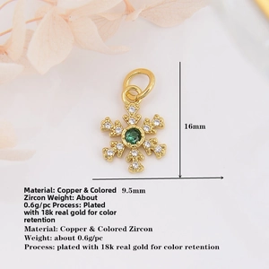 Macro detail of a 16mm snowflake pendant with green zircon and 18k gold plating