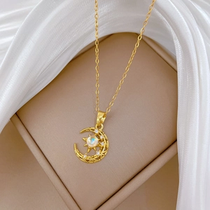 Elegant gold celestial necklace featuring a hollow moon and star pendant with opal stone