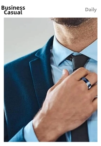 Close-up of a blue and black textured men's spinner ring styled with a navy blue suit