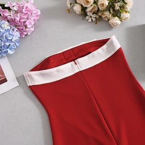 Detail of red and cream contrast bodycon dress featuring a hidden zipper and premium fabric