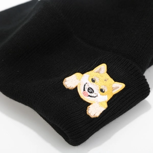 Close-up of cute Shiba Inu embroidery on a black ribbed knit beanie hat for winter