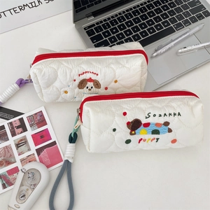 Detail of heart-quilted stationery bag with cute puppy embroidery and red zipper