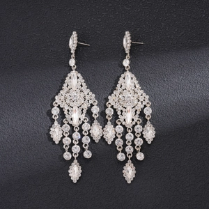 Macro detail of rhinestone chandelier earrings with sparkling gemstone tassels and silver frame