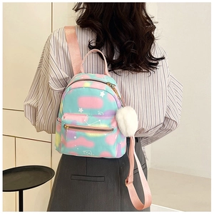 Back view of a mini macaron-colored backpack featuring starry patterns and plush charm