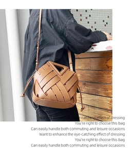 Detail of a brown woven leather handbag with a unique triangular hollow handle design