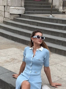 Slim fit light blue knit dress with white polo collar and front button closure