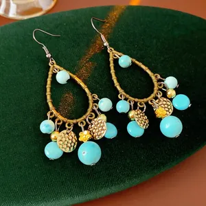 Vintage Bamboo-style teardrop earrings with blue turquoise beads and antique bronze finish