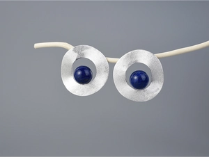 Artistic display of geometric S925 silver stud earrings with dark blue natural stone