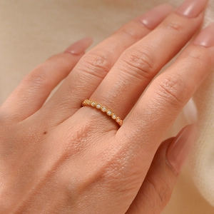 Minimalist S925 silver gold plated ring with micro-pave zircons worn on model's finger