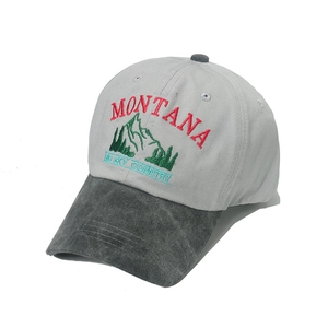 Detailed close-up of mountain embroidery and vintage wash on a baseball cap