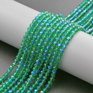 Macro shot of 4mm green faceted crystal glass beads with iridescent coating for DIY jewelry
