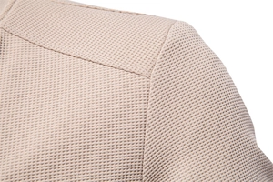 Detail of waffle knit fabric and shoulder seam on men's apricot stand collar jacket