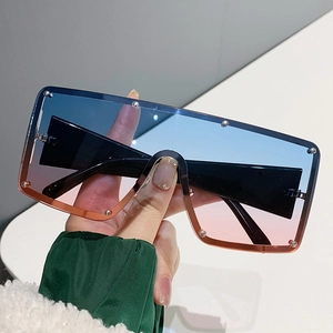 Modern oversized square sunglasses with blue to pink gradient lenses and silver rivet details