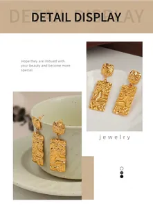 Detail of gold rectangular drop earrings with hammered texture and fluid metal effect