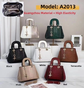 Detail view of crocodile pattern handbags in seven colors with multi-compartment interior