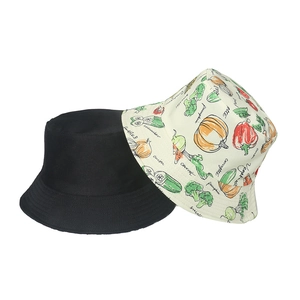 Reversible bucket hat featuring hand-drawn vegetable patterns and a solid black side