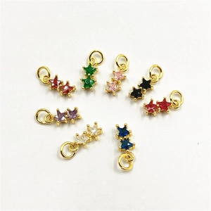 Macro detail of star-shaped jewelry pendants with colorful cubic zirconia and gold plating