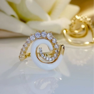 Luxurious gold ring with white enamel spiral and sparkling zircon inlays for women