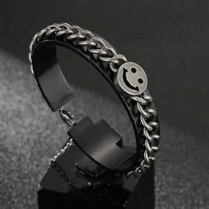 Vintage stainless steel chunky chain bracelet with smiley face pendant on a black stand