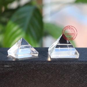 Macro shot of two transparent natural white crystal pyramids in outdoor natural light
