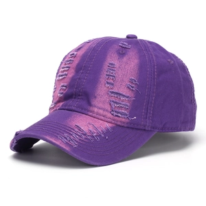 Close-up of distressed purple washed denim cap with metallic finish and ripped details