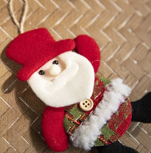 Detail of Santa Claus ornament with plaid fabric and rustic jute rope hanger