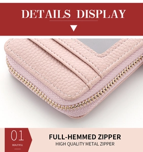 Detail of pink pebbled leather card holder featuring high-quality metal zipper and stitching