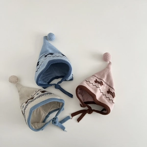 Cute knitted baby earflap hats with pom-poms in blue, pink, and beige colors