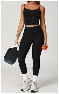 Close-up of black strapless crop top and high-waisted leggings with matte elastic fabric