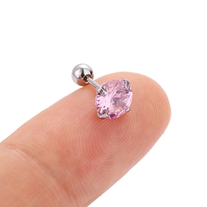 Pink zircon threaded tragus stud earring in silver finish shown on a fingertip
