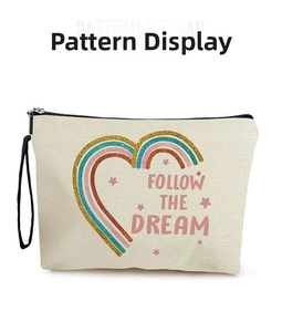 Close-up of rainbow heart glitter print and Follow the Dream text on canvas makeup bag