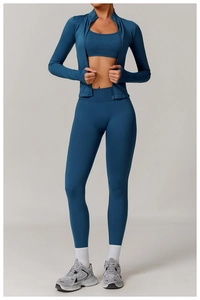 Three-piece seamless yoga set in peacock blue including zip jacket, bra, and high-waist leggings