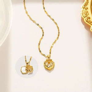 Detail showing the opening shell pendant on a gold titanium steel double-layer necklace
