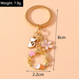 Detail of cartoon cat keychain with cherry blossom pendants and dimension markings