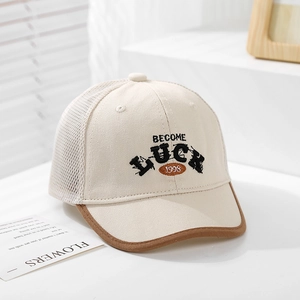 Close-up of baby mesh baseball cap with Luck embroidery and brown faux leather brim edge