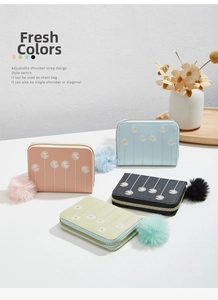 Detail view of mini plush purses with daisy embroidery and soft pompom charms in four colors