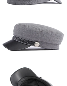 Detail view of grey wool newsboy cap featuring black leather brim and silver buttons