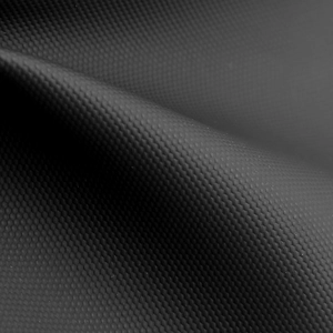 Close-up of waterproof black fabric with honeycomb hexagonal texture on the chest bag