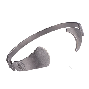 Irregular vintage matte grey metal open bangle with embossed leaf pattern detail