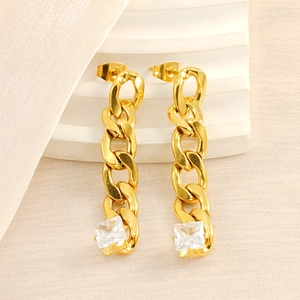 Fashion gold Cuban chain drop earrings with square zircon on white marble background