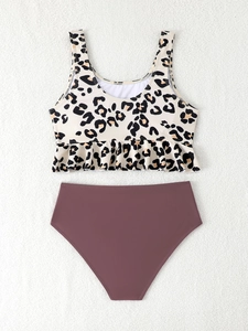 Flat lay of leopard print ruffle bikini top paired with high-waisted burgundy swim bottoms