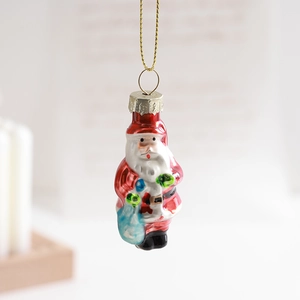 Glossy red Santa Claus glass ornament with gold string hanging for Christmas decor