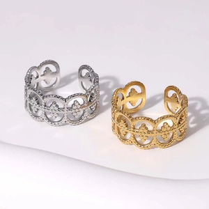 Hollow pattern stainless steel rings in gold and silver finish on white background