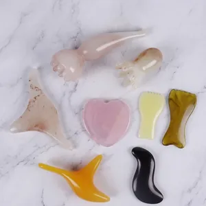 Resin massage tool set with pink heart scrapers and green meridian combs for face spa