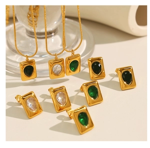 Macro view of water-drop emerald green pendant with 18K gold plated snake chain